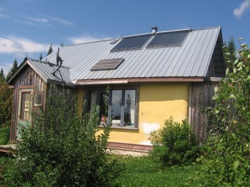 Evacuated Tube Solar Hot Water Panels & Photovoltaic Panel on Artist cabin