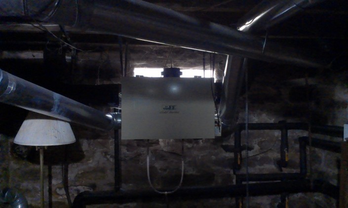 Heat exchanger unit. The original building's foundations are visible in the background.